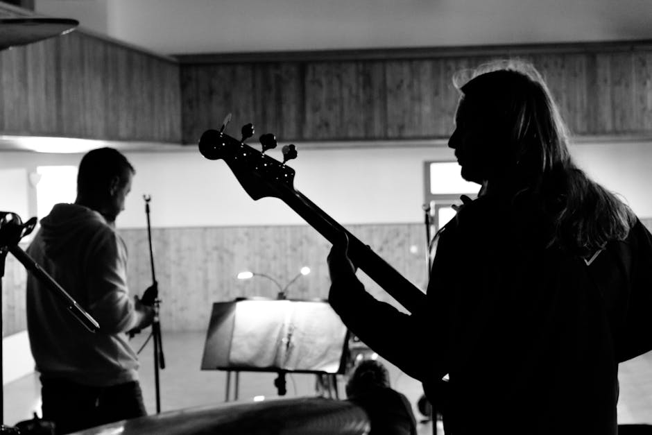 Young musicians rehearsing together in a bright room.